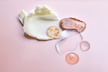 Different cosmetic textures on a delicate peach background. 