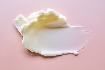 Texture of cosmetic butter on a pink background. Showcasing a thick and nourishing texture.
