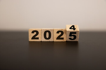 2025 business growth, acceleration concept. New year business goals, plan, strategy. Flipping wooden cubes to 2025 and growth performance. Banner for the new action plan ,annual plan, growth, target.