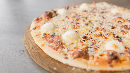 cheese pizza served in a pizzeria, close-up on the right side of the photo