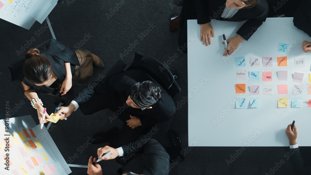 Poster top down aerial view of business group sharing and brainstorming idea by using sticky notes at meeti