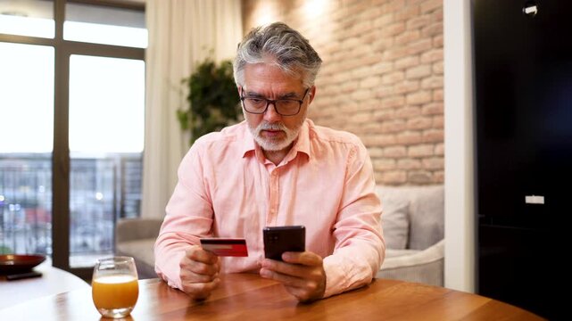 Surprised senior man tried to make an online purchase and realized that he is being scammed
