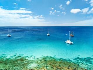 Fototapeta premium White sandy beach and blue water in Morro Jable, south of Fuerteventura, Canary islands