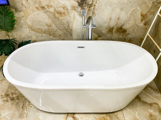 Experience the ultimate relaxation in an elegant freestanding bathtub, complete with a sleek modern...