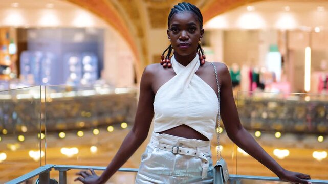 Black woman with braids staring at the camera, inside a chapelle