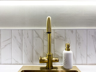 Discover the beauty of an Elegant Gold Faucet featuring a Modern Design, perfectly placed in a...