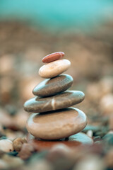 A pyramid of stones on a pebble beach by the sea, the concept of balance, balance, tranquility, relaxation