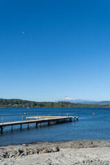 Obraz premium View of a pier in a blue lake during a summer day