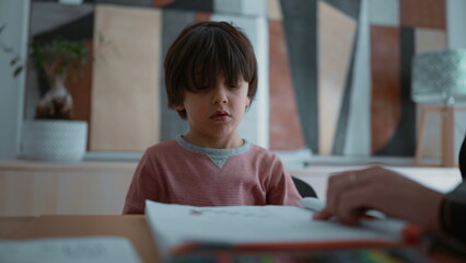 Child reluctant and struggling with learning, showing frustration and difficulty during a learning...