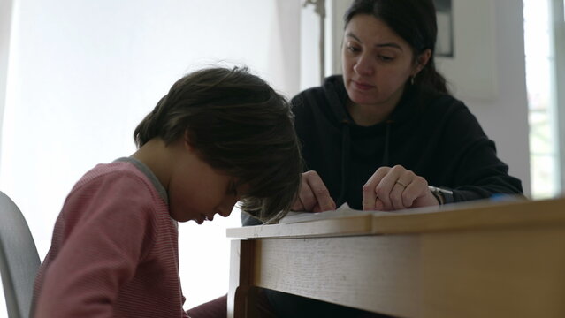 Parent and child engaged in an intense study session, highlighting the challenges and concentration required for effective learning in a home environment