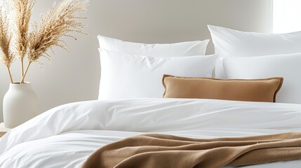 A close-up of a neatly made bed with crisp white linens, fluffy pillows, and a cozy throw blanket, with copy space, high-resolution photo, realistic photo