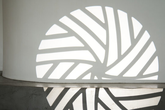 The silhouette of the gobo mask on the wall surface with space to copy. A step ledge with a shadow from a light stroke. High quality photo