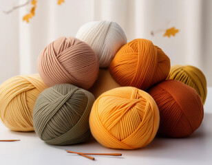 Autumn colored yarn balls for knitting on a white background.