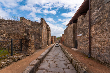 Fototapeta premium Pompeii, Naples / Italy - 04.26.2024 : Famous ancient city of Pompeii near Naples. Paths and ruins in ancient Pompeii, Campania, Italy
