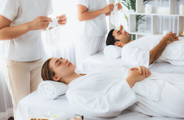 Fototapeta premium Serene modern daylight ambiance of spa salon, couple customer indulges in rejuvenating with facial skincare mask. Facial skin treatment and beauty cosmetology procedure for face. Quiescent