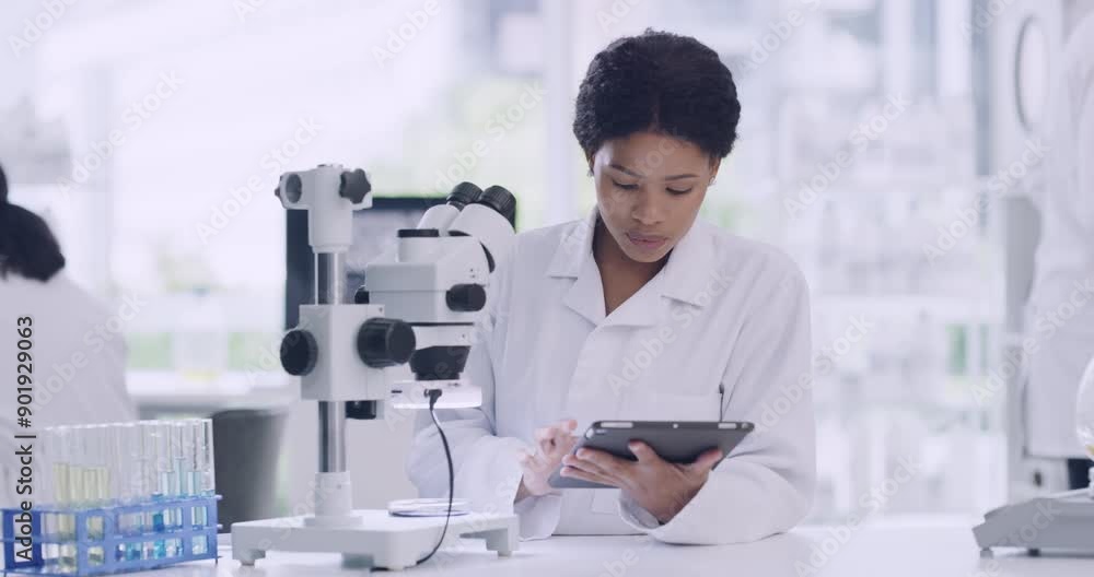 Aufkleber female scientist using a microscope and tablet at a medical research lab. focused woman looking at s