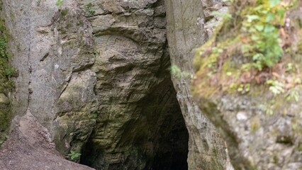 Engraved Cave Entrance in Rocky Terrain