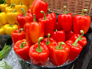 Bowl of red peppers on display on a market grocery stall. No people.