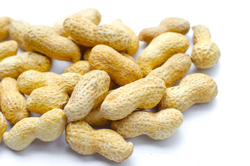 Roasted peanuts in shell on white background.