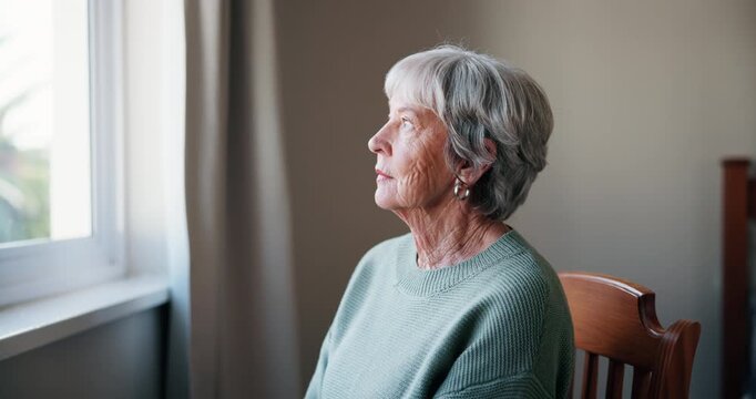 Lonely, senior woman or depression with thinking of memory, mental health or nostalgia with dementia in retirement. Elderly person, window or alzheimer with grief, waiting or remember in nursing home