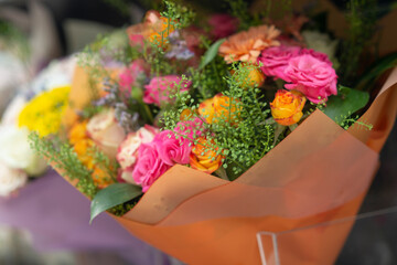 Beautiful bouquets in a row in a florists shop front with an urban background