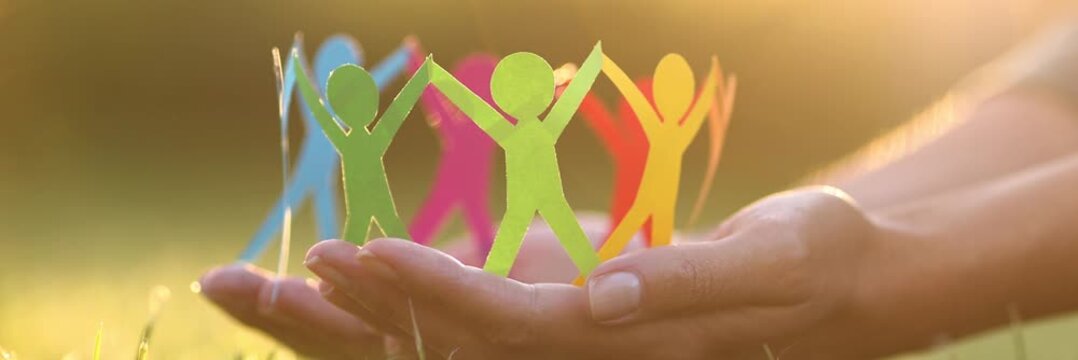 Silhouettes of people of different colors united. Help and protection concept