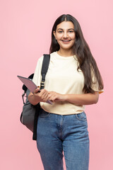 Cheerful young student girl with backpack using digital tablet for remote education