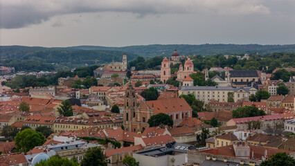 Scenic View of Vilnius, Lithuania Showcasing Historic Architecture and Lush Green Surroundings Under a Cloudy Sky