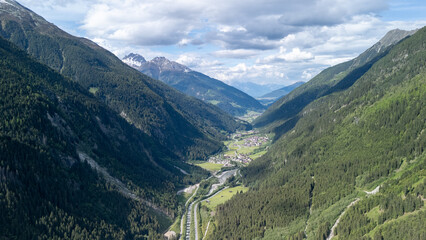 Spectacular Aerial View of Valleys Surrounded by Majestic Mountains in Switzerland on a Clear Day