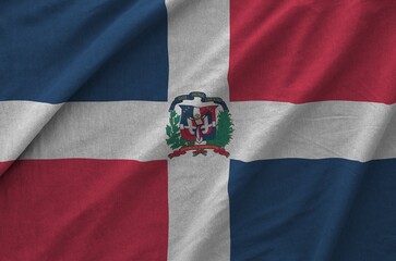 Dominican Republic flag depicted on folded wavy fabric of old cloth close up