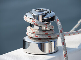 A Sailboat self tailing jib sheet winch with coiled red and white line