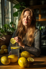 Young Woman Adding Lemon to Water, Refreshing Drink Preparation, Healthy Living Concept