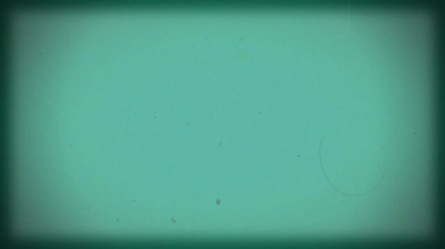 Vintage turquoise film background with vignette. Copy space on centre. Old retro film camera, textured background. Scratches, details and noise. Dusty and grainy feel. 4K motion graphics