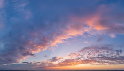 Ideal for Sky replacement project: Panoramic, colorful pink-orange-blue dramatic sky with clouds illuminated by red sunset, aerial photography, far horizon without obstacles.