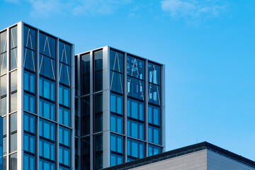 Fototapeta premium fragments office and residential buildings in European city with reflective glass facades, modern high-rise office buildings and residential towers