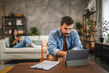 adult caucasian man work on digital tablet at home