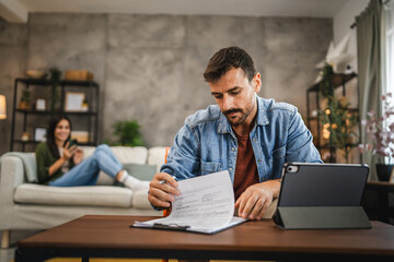 adult caucasian man work on digital tablet at home