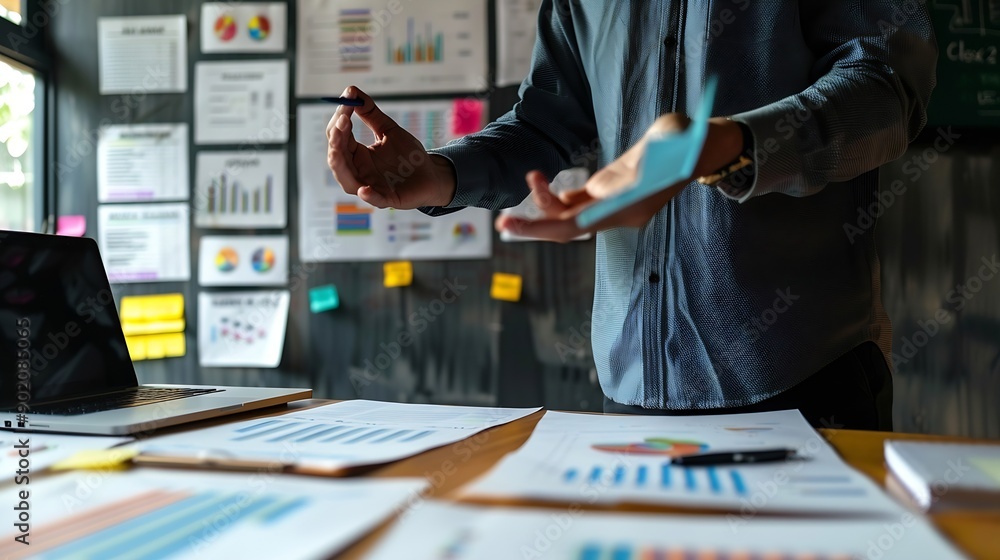 Leinwandbilder Man chart and mentor in meeting for strategy brainstorming and talking in office presentation Male person planning and leader teaching in workshop speaking and support in staff trainin : Generative AI