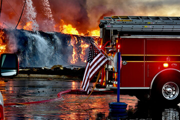 American flag on back of fire engine with flames