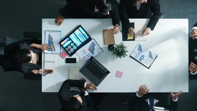 Top down aerial view of smart businessman use vr headset to enter virtual world at meeting while diverse business people send financial information and data analysis graph in database. Directorate.