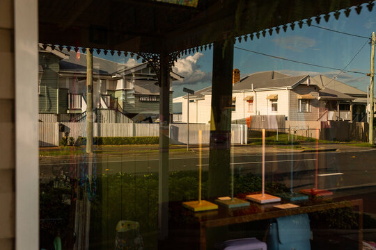 houses reflected in a Latrobe Terrace shop window