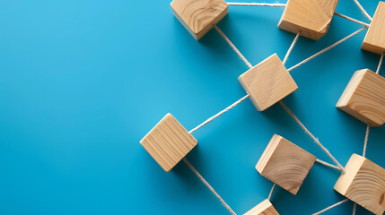 Wooden blocks connected together on a blue background. Teamwork concept