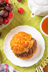 Profiteroles with chocolate cream on white plate .  