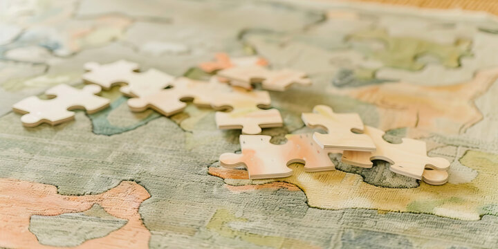A wooden puzzle, its pieces scattered on a rug, inviting someone to work on putting it back together again