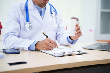 doctor writing on clipboard