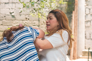 A woman overcome with fury wrestles with and pulls at the hair of her enemy. Raging over dispute or...