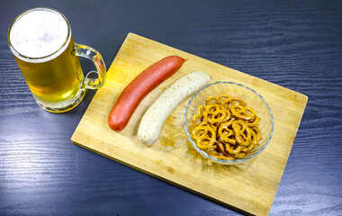 German Sausages, Pretzels in Crystal Bowl, and Beer Jar on Wooden Tray