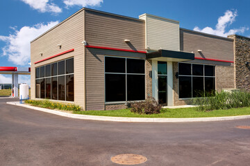 Modern building with a large glass facade and a beige brick base.  The architectural design suggests that this building could be an office or institutional structure.