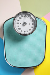 One bathroom scale on color background, top view