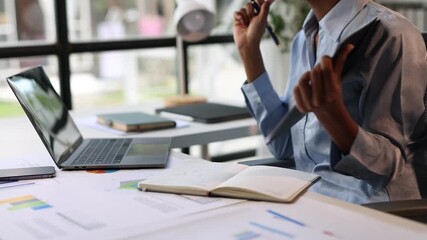 Confident businesswoman in a modern office, participating in a virtual meeting and reviewing financial reports during a video conference call. - Powered by Adobe